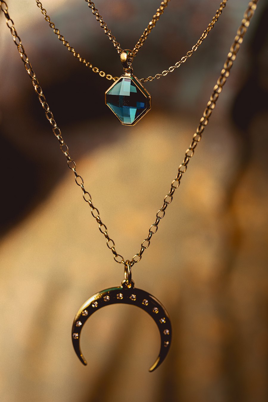 Gold chain pendant with a crescent charm