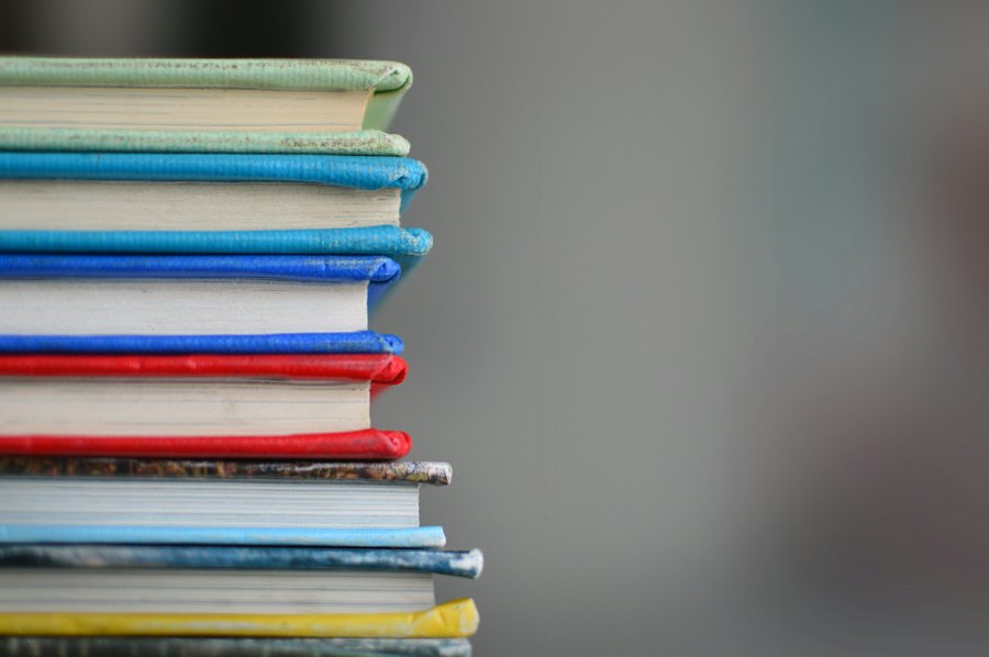 A tall stack of colourful hardback books